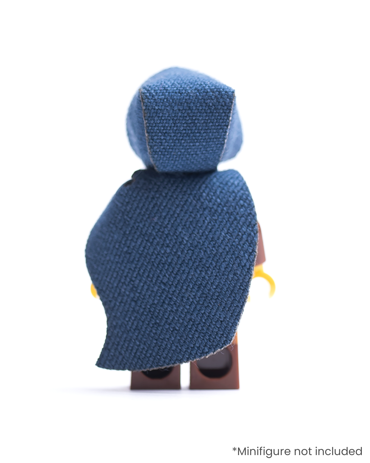 Rear view of LEGO minifigure with brown outfit and blue hood and cape on a white background