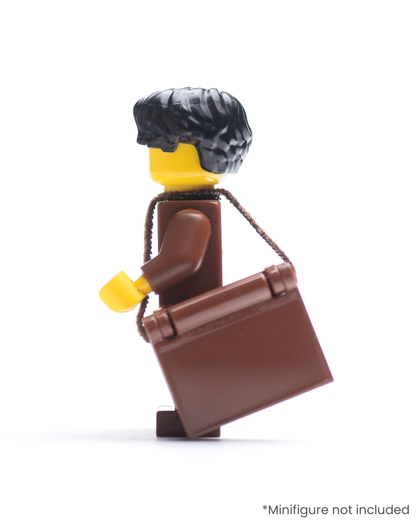 Side view of LEGO minifigure with a book in a strap over its shoulder