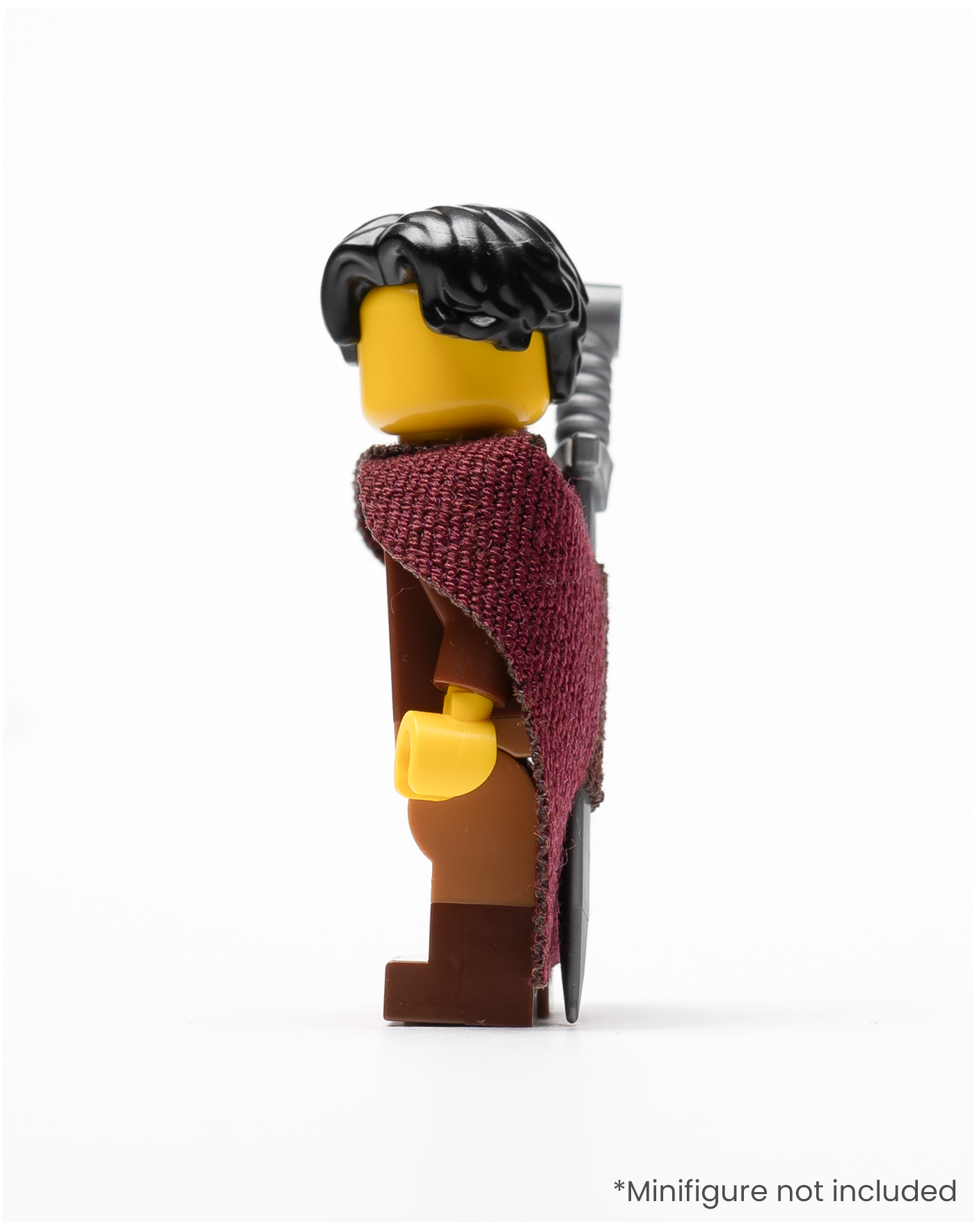 Profile of a LEGO minifigure wearing a sword in a sheath on its cape