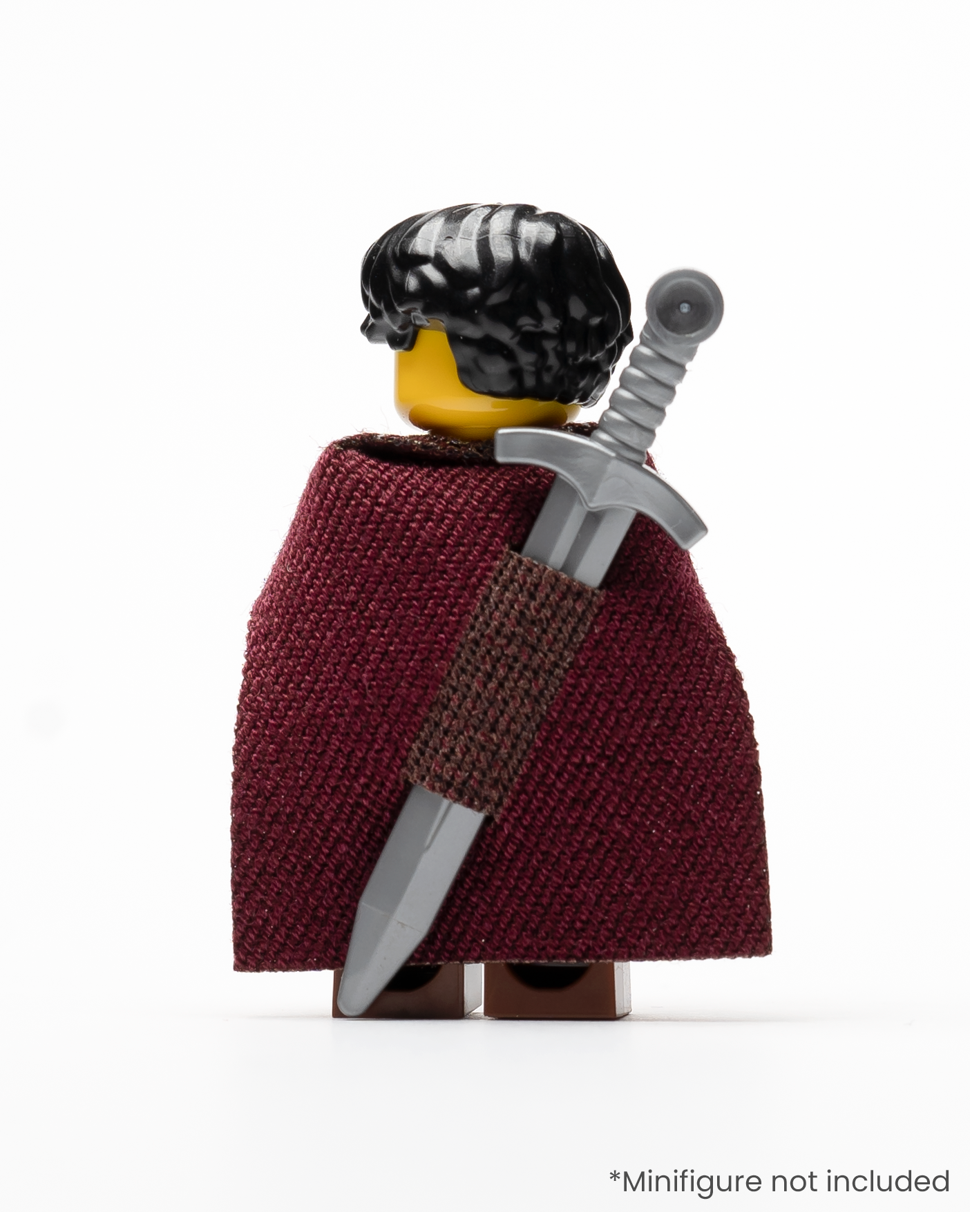 A LEGO minifigure wearing a sword in a sheath integrated into a cape on its back